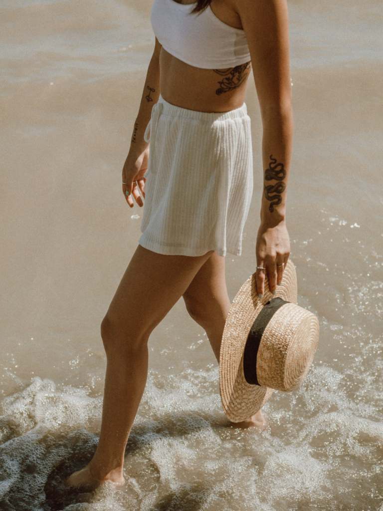 woman wearing bralette and shorts in the ocean