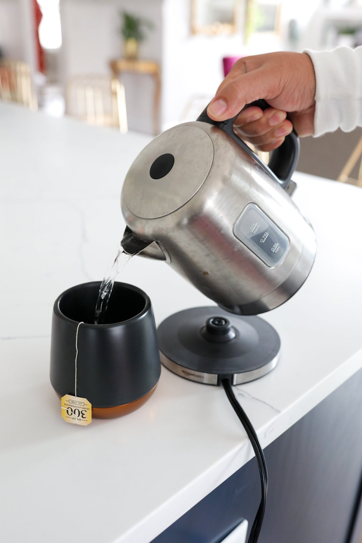 Amazon Stainless Steel Kettle pouring hot water into a mug with tea bag