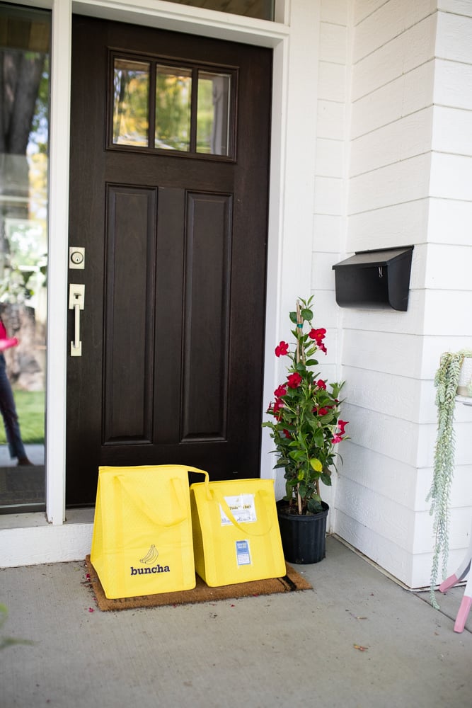 Buncha food bags waiting at someone's front door