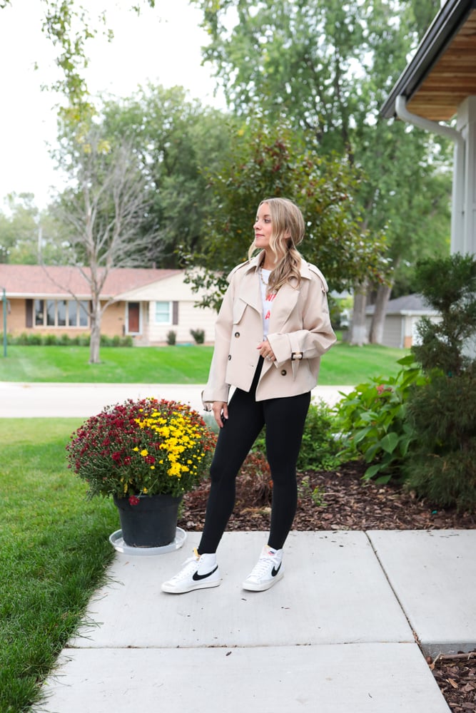 woman in leggings, nikes and cropped trench coat