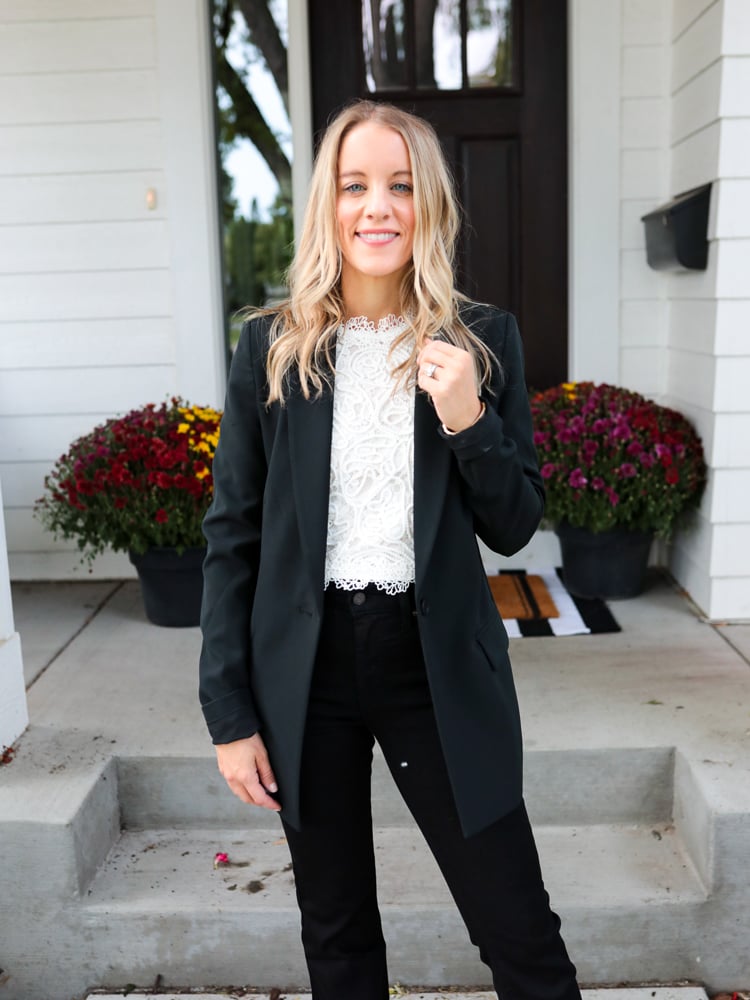 woman in black blazer, lace top and black jeans