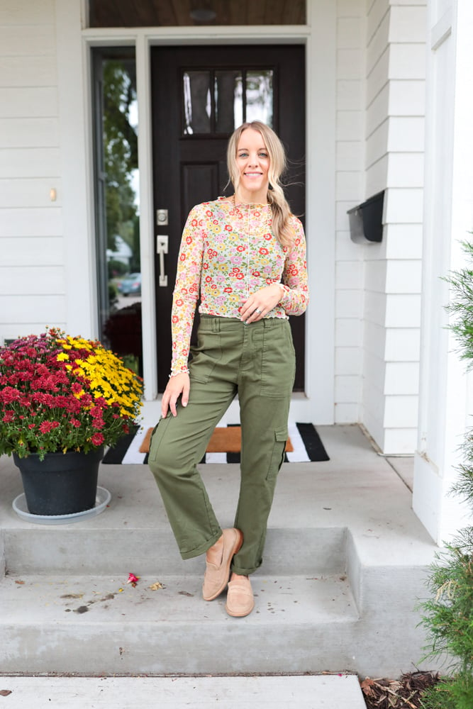 woman wearing green cargo pants, sheer floral top and loafers