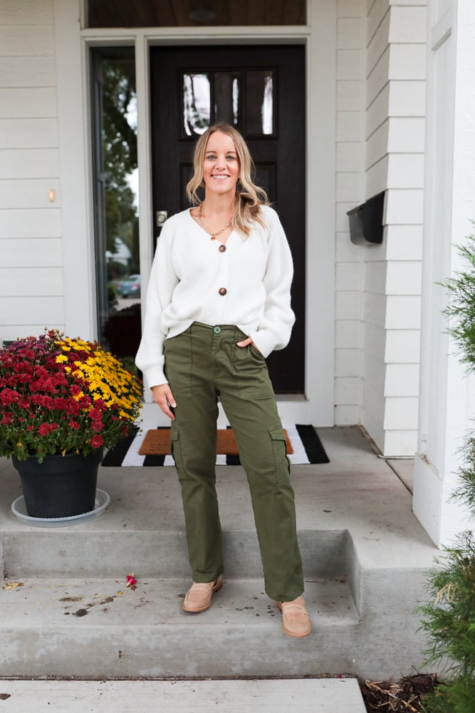 woman wearing green cargo pants, white cardigan and loafers