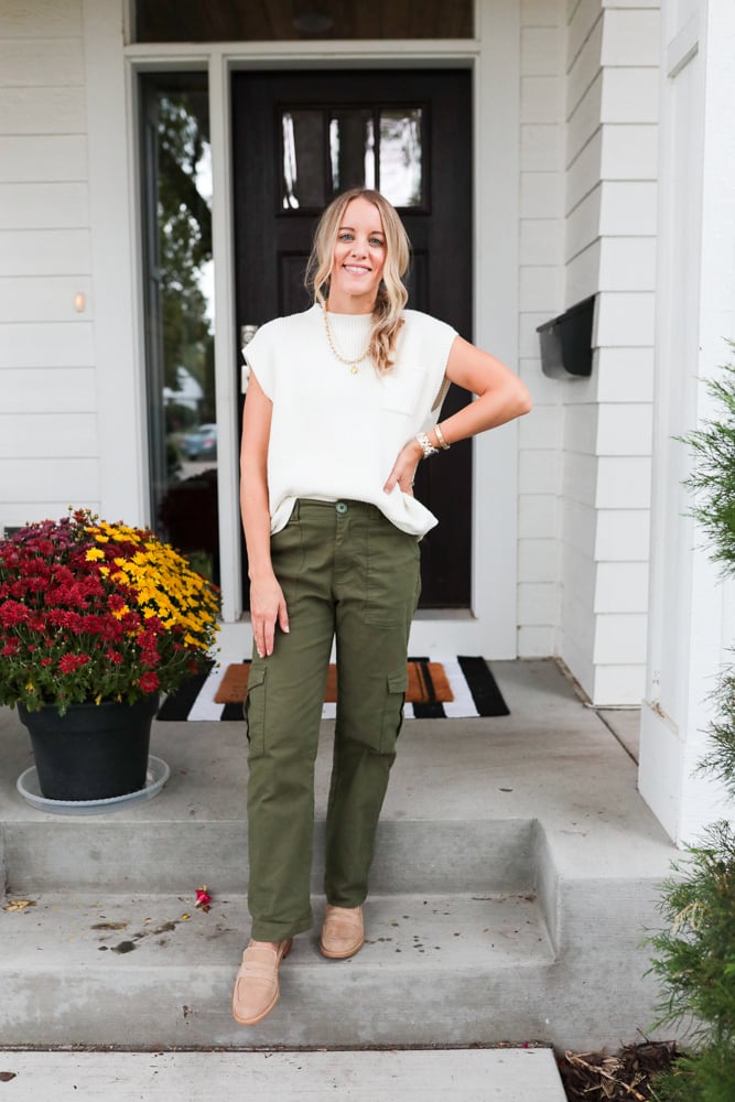 woman wearing green cargo pants, white sweater tank and loafers