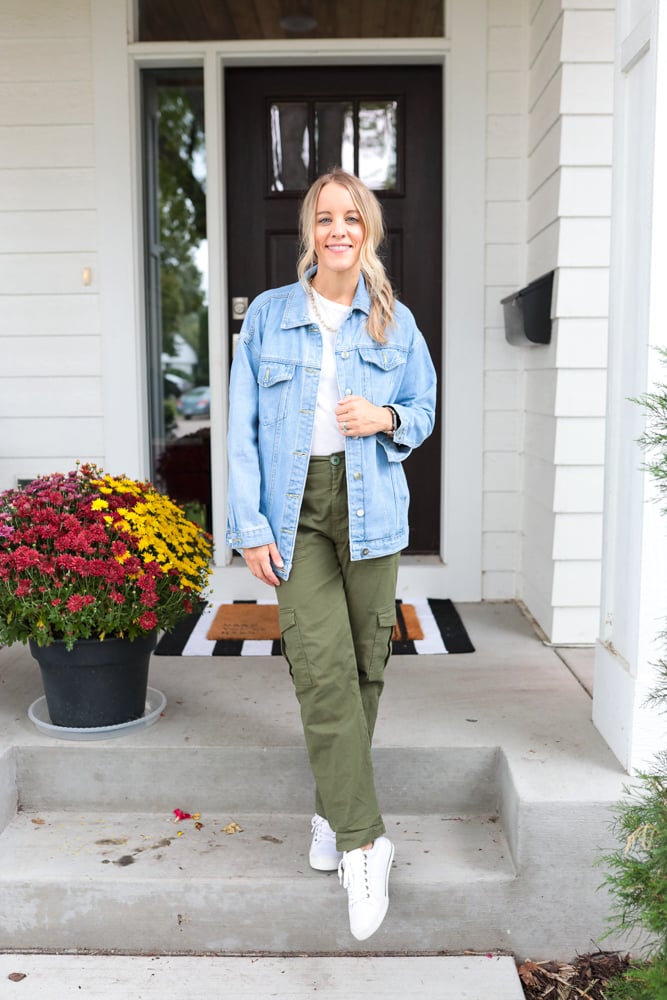 woman wearing green cargo pants, white t-shirt, oversized denim jacket and white sneakers