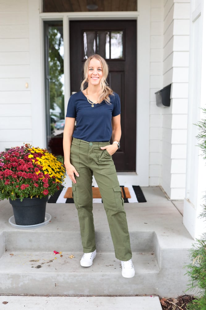 woman wearing green cargo pants, navy blue tshirt and white sneakers