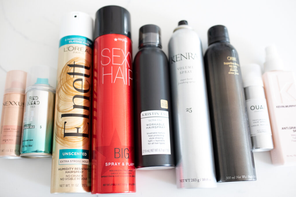 variety of hairspray laid out on a table
