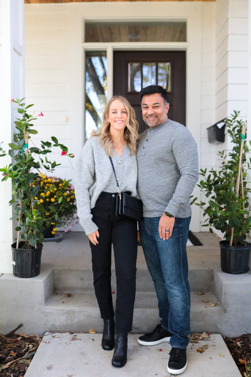 woman and man wearing coordinating grey tops and black shoes