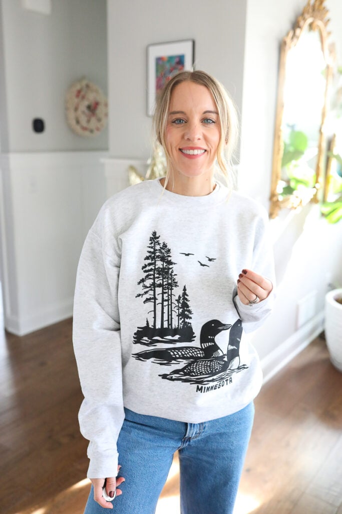 woman wearing sweatshirt with loon on it