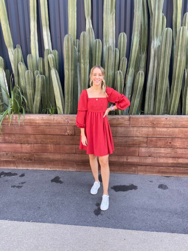 woman wearing colorful mini dress and white sneakers