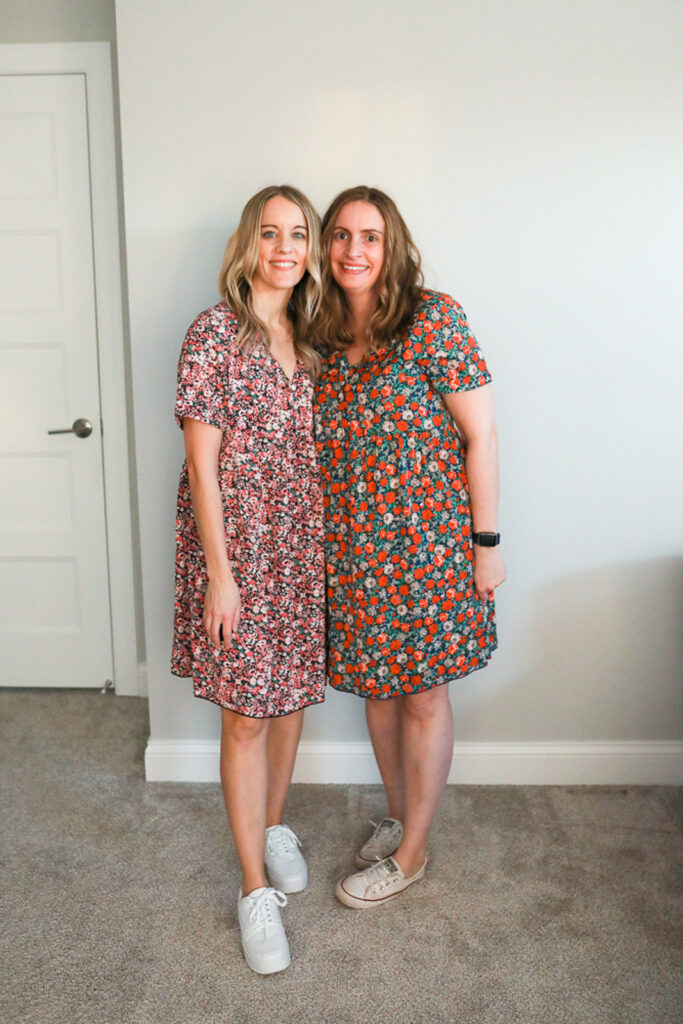 two women wearing floral dress and sneakers