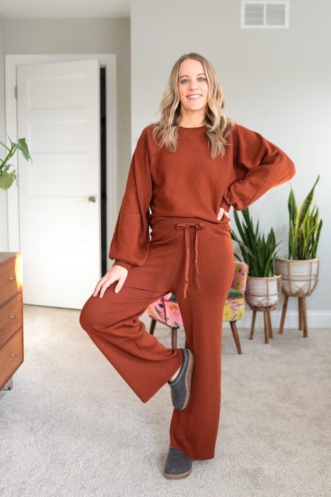 woman wearing rust colored lounge set with haflinger slippers