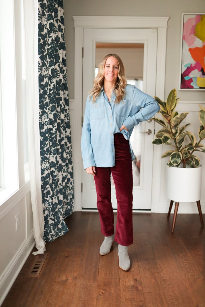Woman wearing burgundy pants and chambray top.