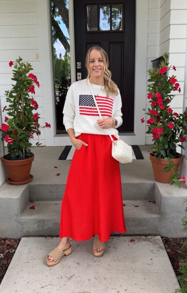 Woman wearing red skirt and American flag sweater.