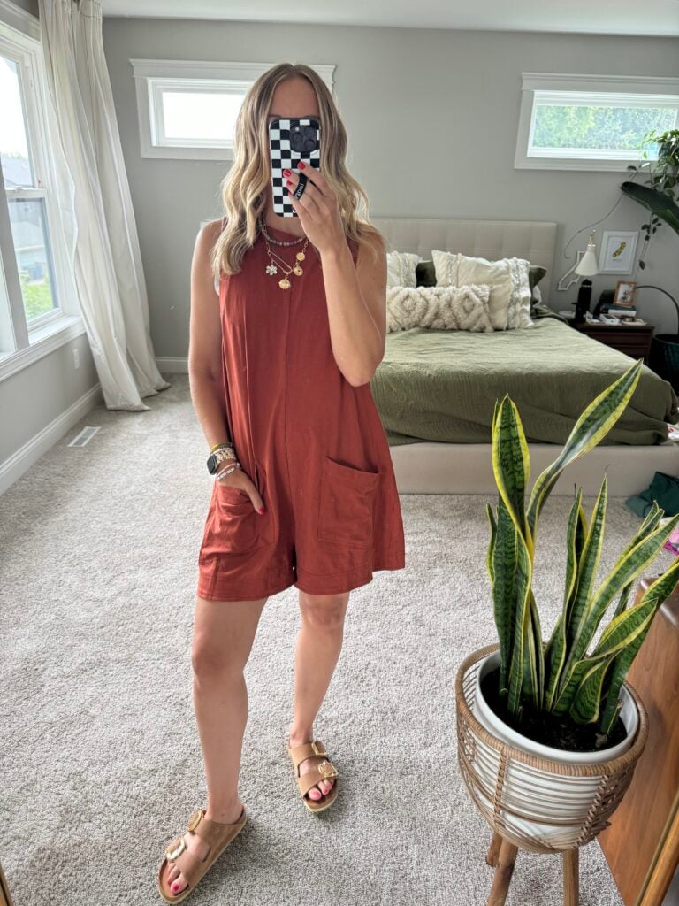 Woman in rust colored romper set.