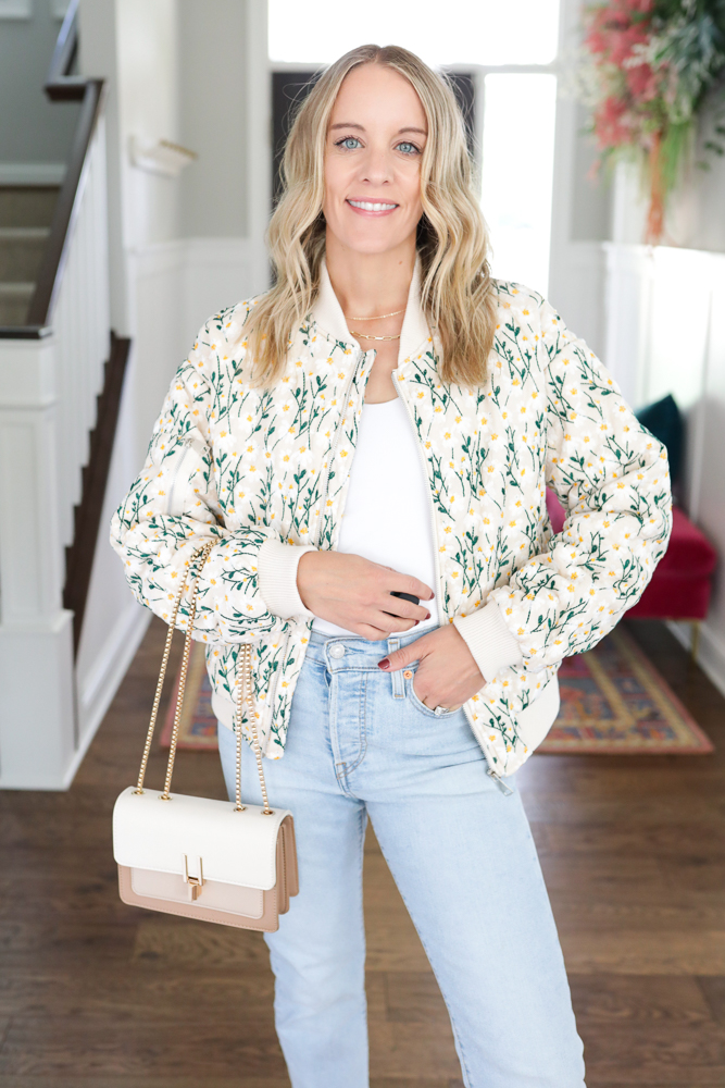 Woman wearing floral jacket.