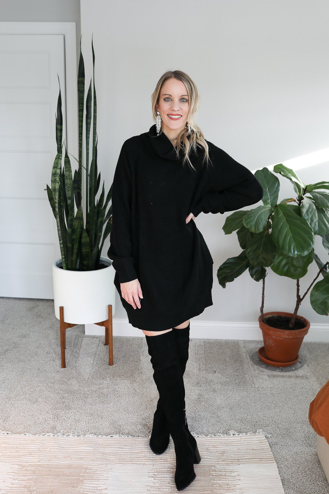 woman wearing turtleneck sweater dress and knee high black boots