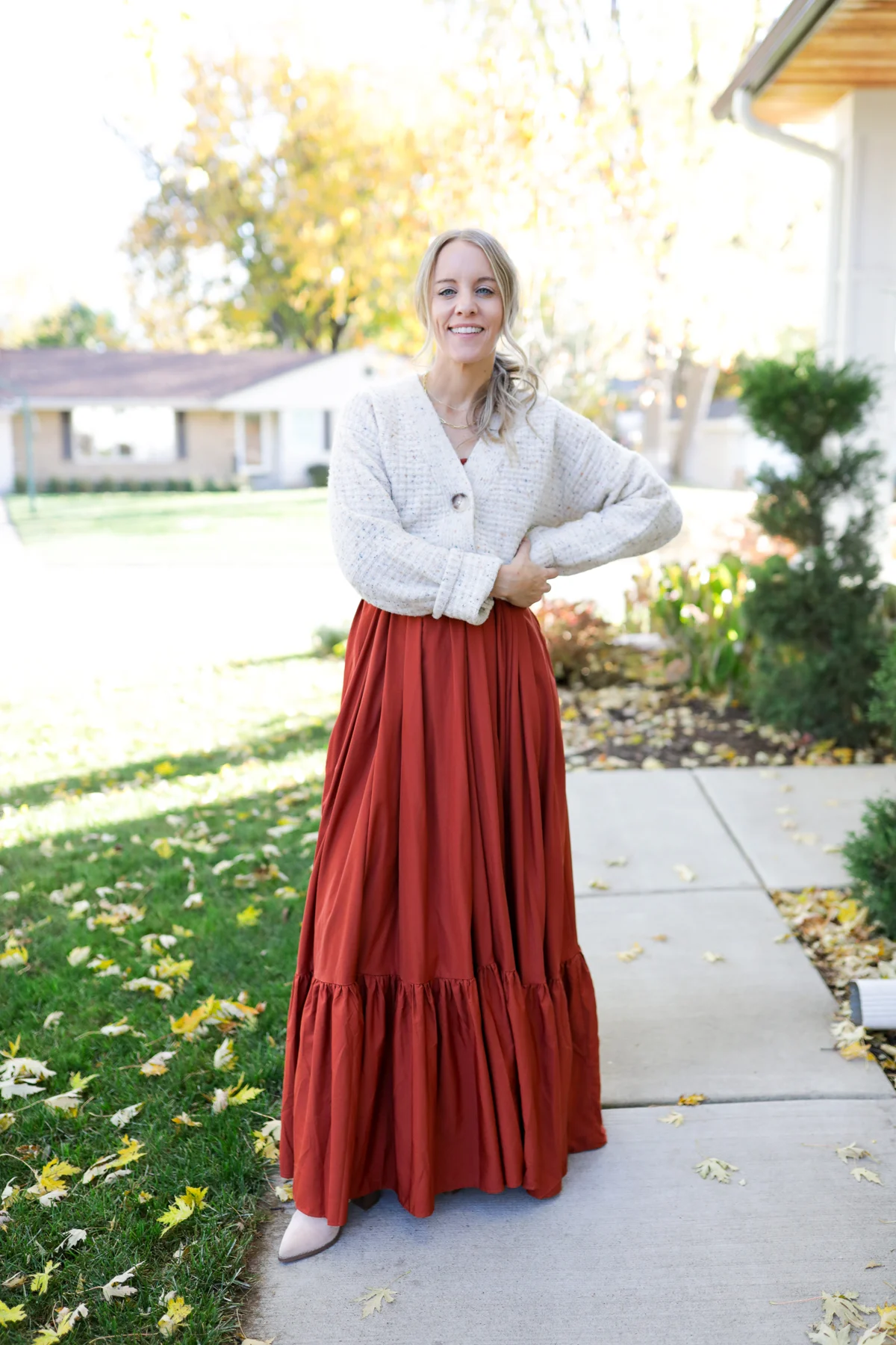 woman wearing a chunky cardigan and tiered maxi dress