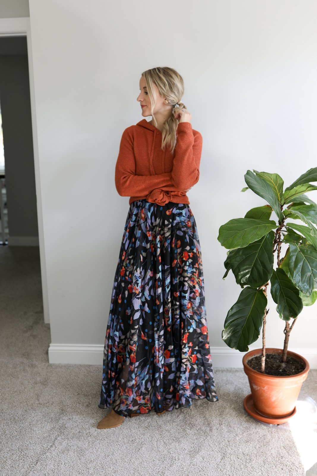woman wearing a hoodie, floral skirt