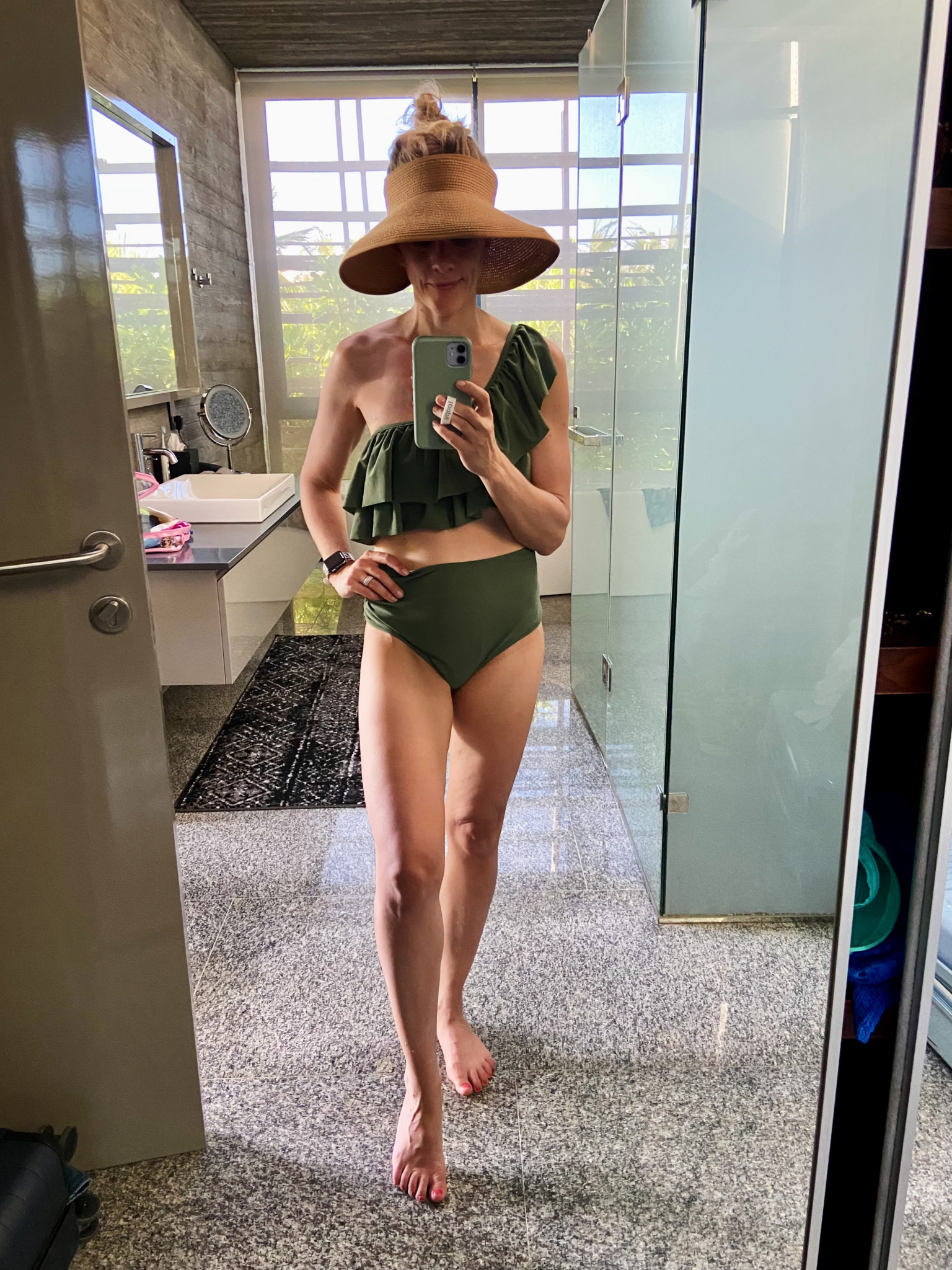 woman wearing resort wear look consisting of a green bikini 