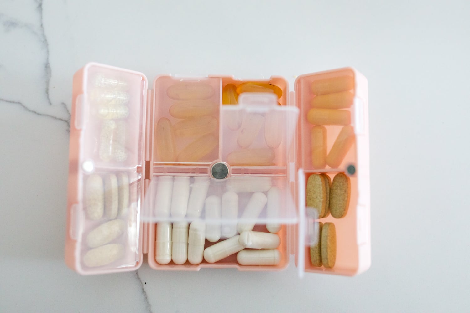 travel essentials featuring a pill organizer