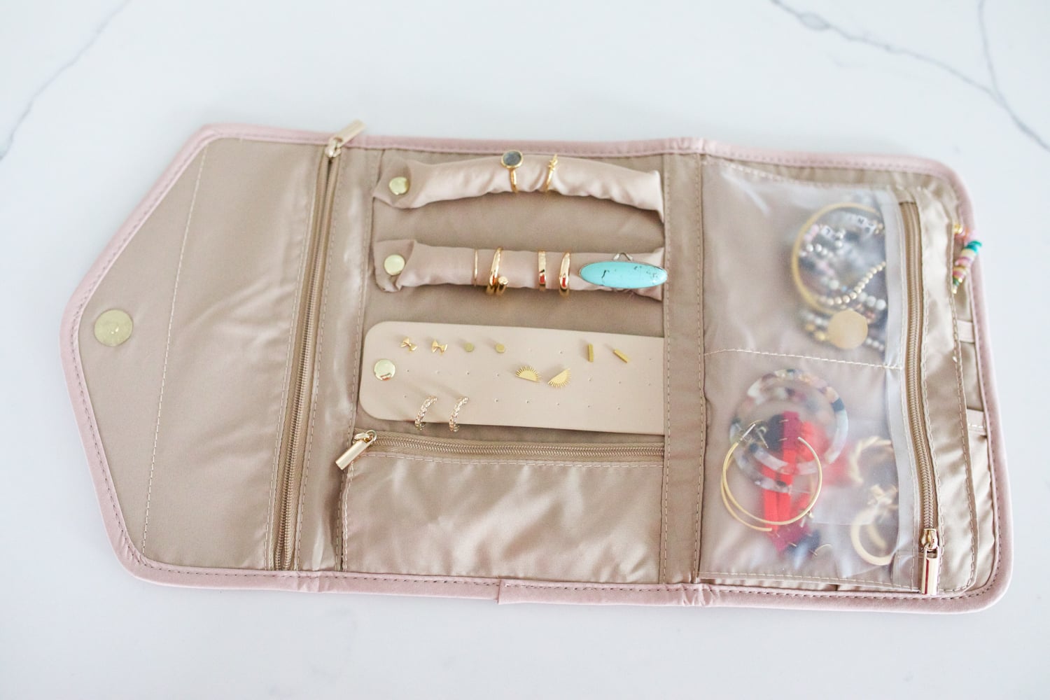 travel essentials featuring a jewelry organizing travel bag