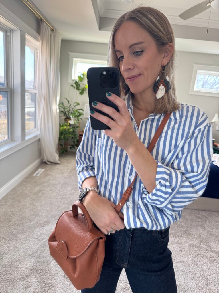 woman wearing blue striped button down and blue jeans