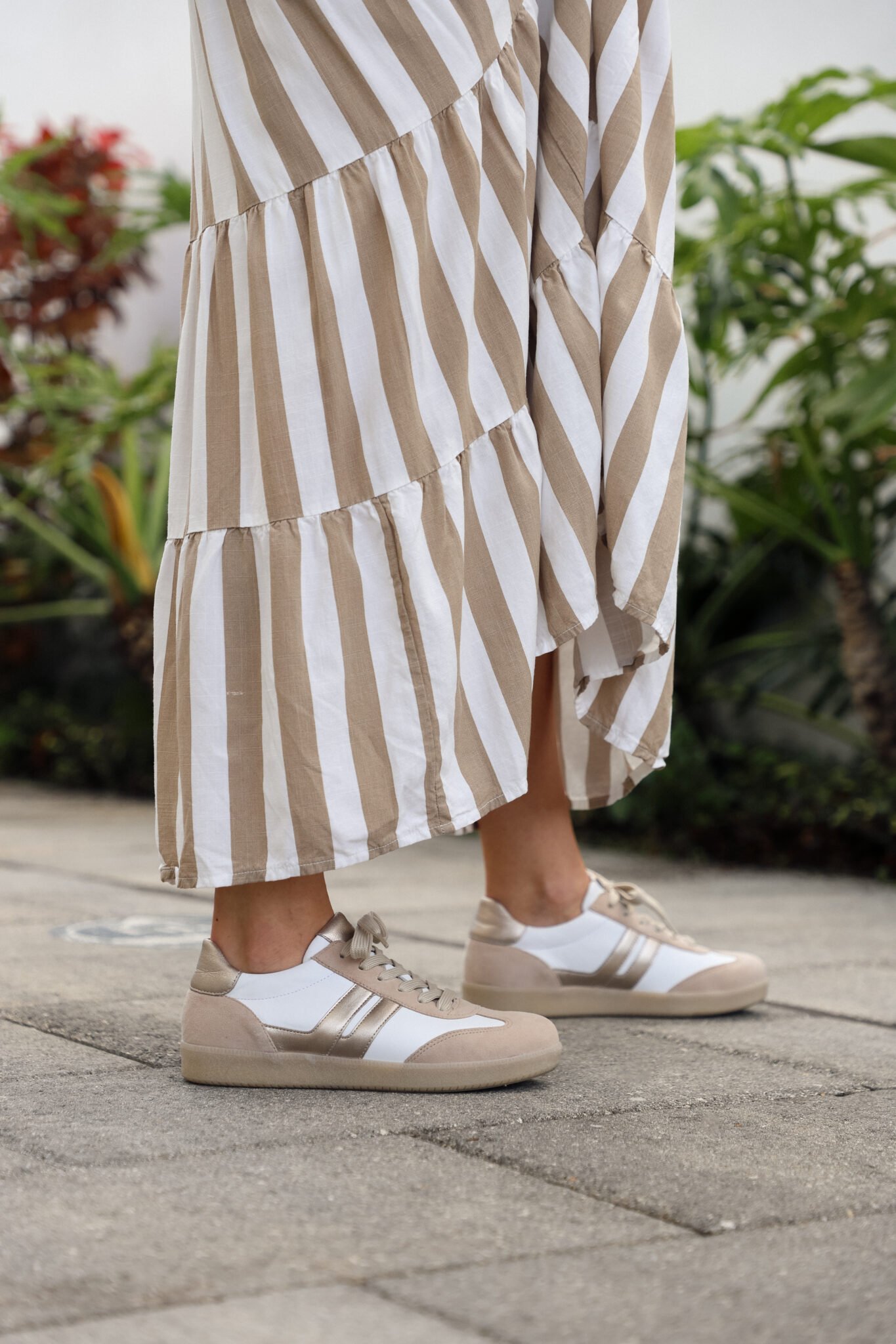 woman wearing striped maxi dress and neutral shoes