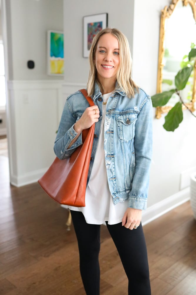woman wearing a distressed denim jacket with a casual look. 