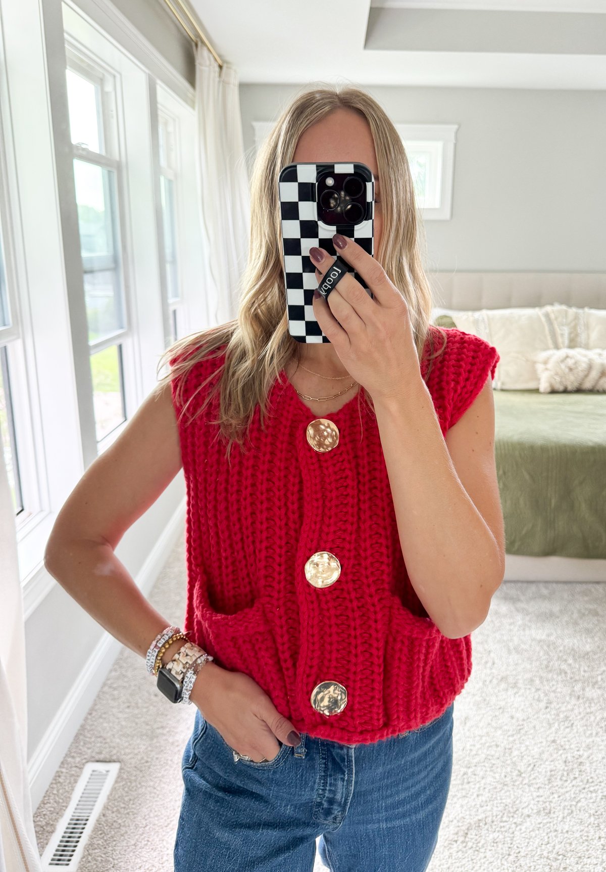 woman wearing red sweater vest