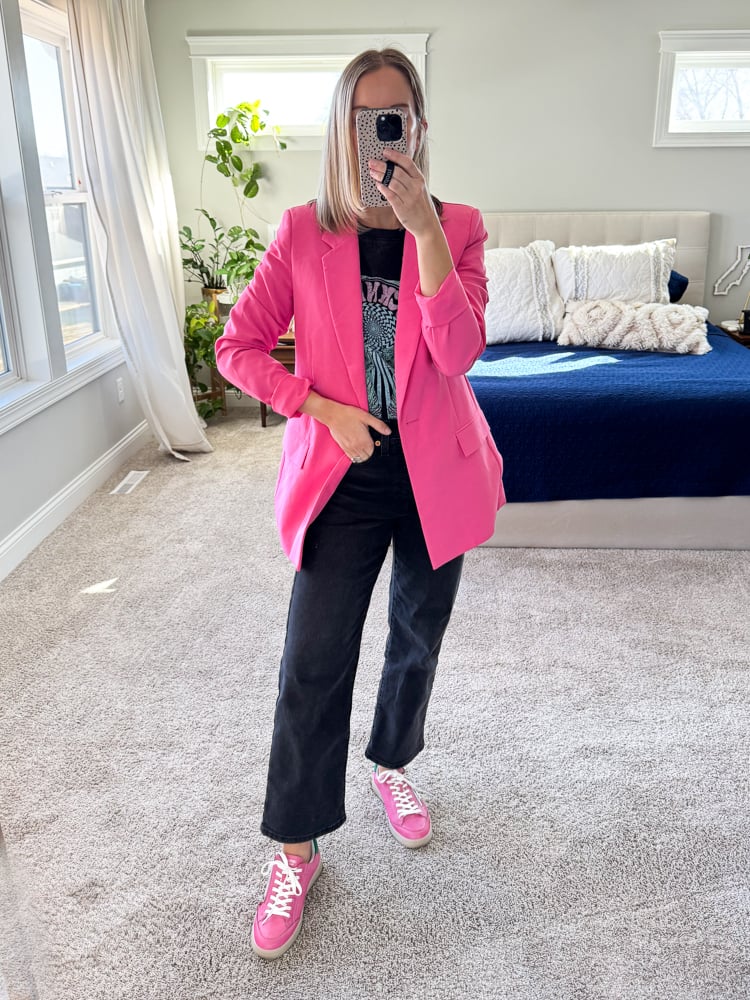 woman wearing pink blazer and graphic tee with sneakers