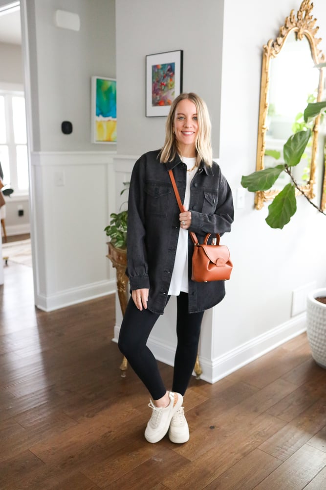 woman wearing black denim jacket and leggings