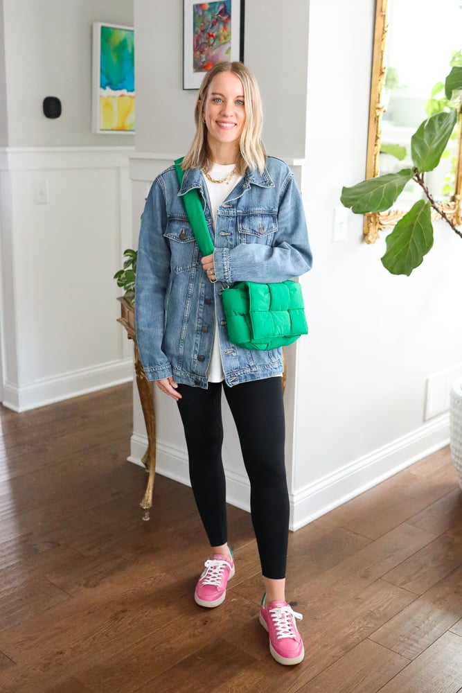 woman wearing casual outfit with a denim jacket and pink sneakers