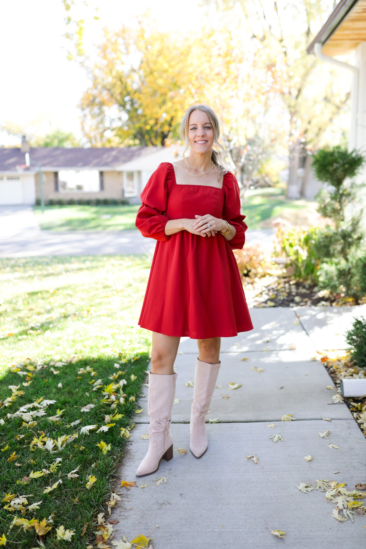 woman wearing red dress and suede boots