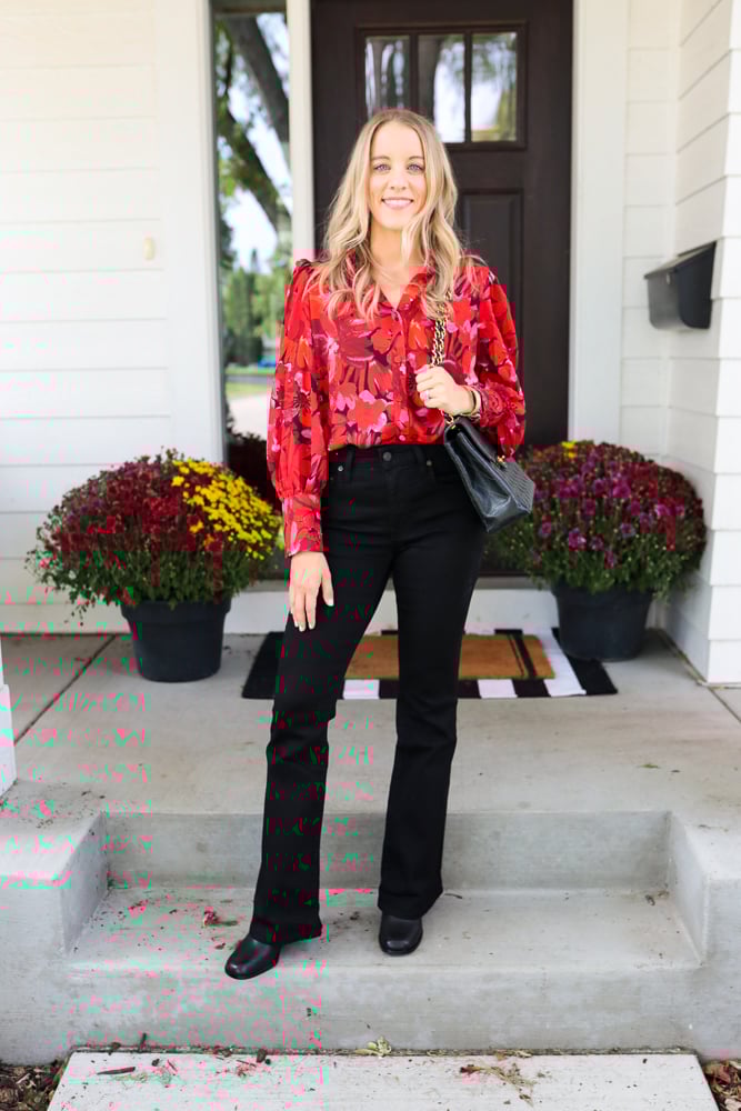 woman wearing red blouse and black jeans