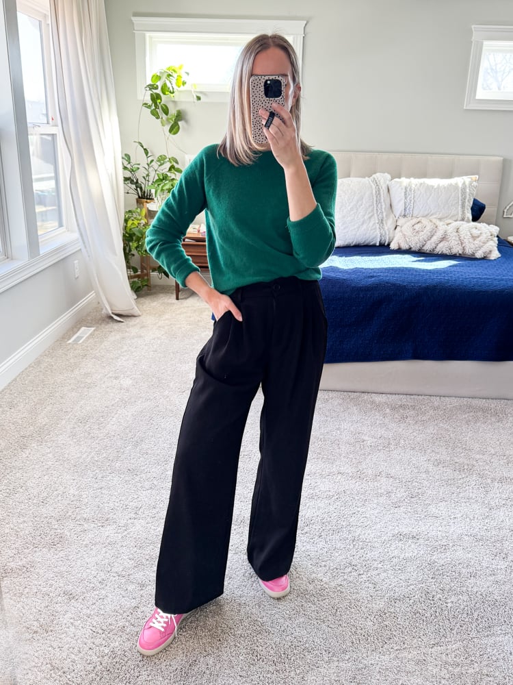 woman wearing green sweater and trousers with pink sneakers