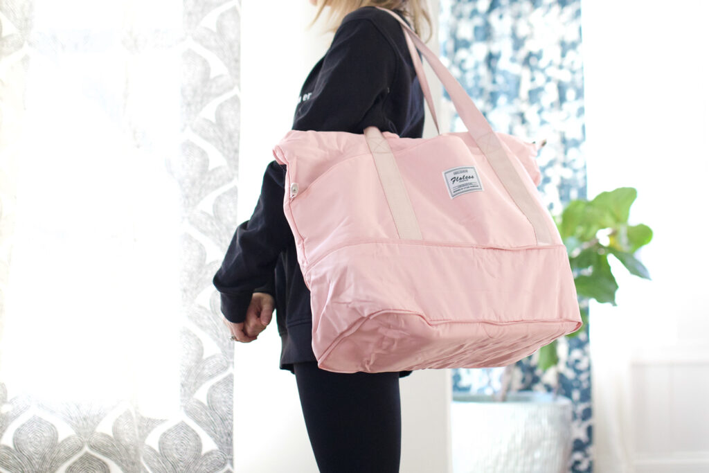 Woman holding a pink sports bag