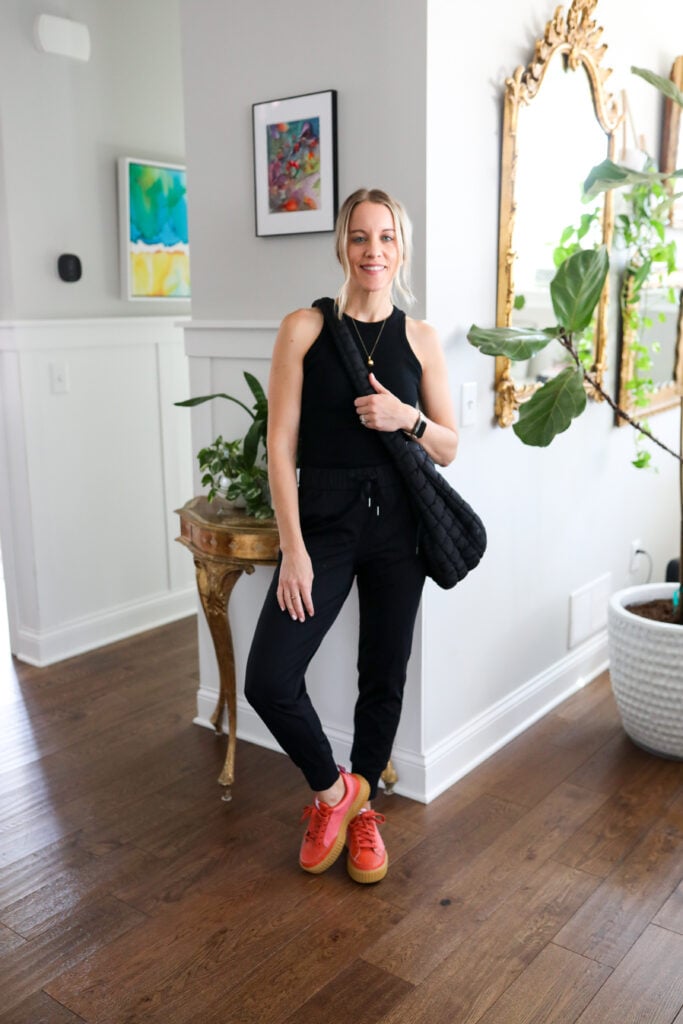 Woman in joggers and tank with colorful shoes