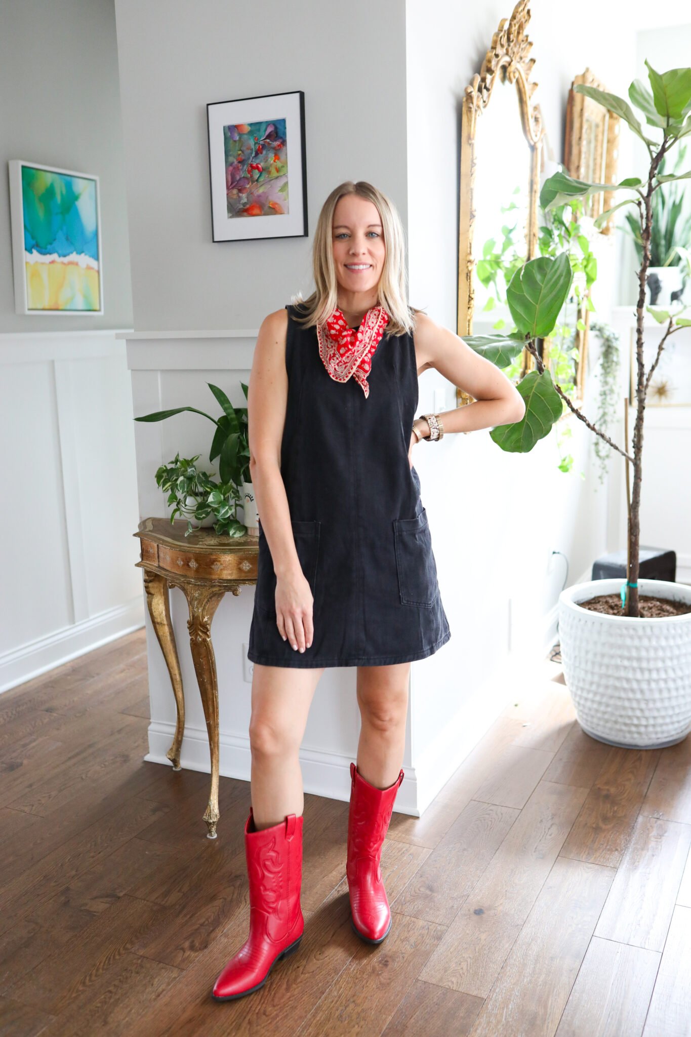 woman wearing a black dress and red boots