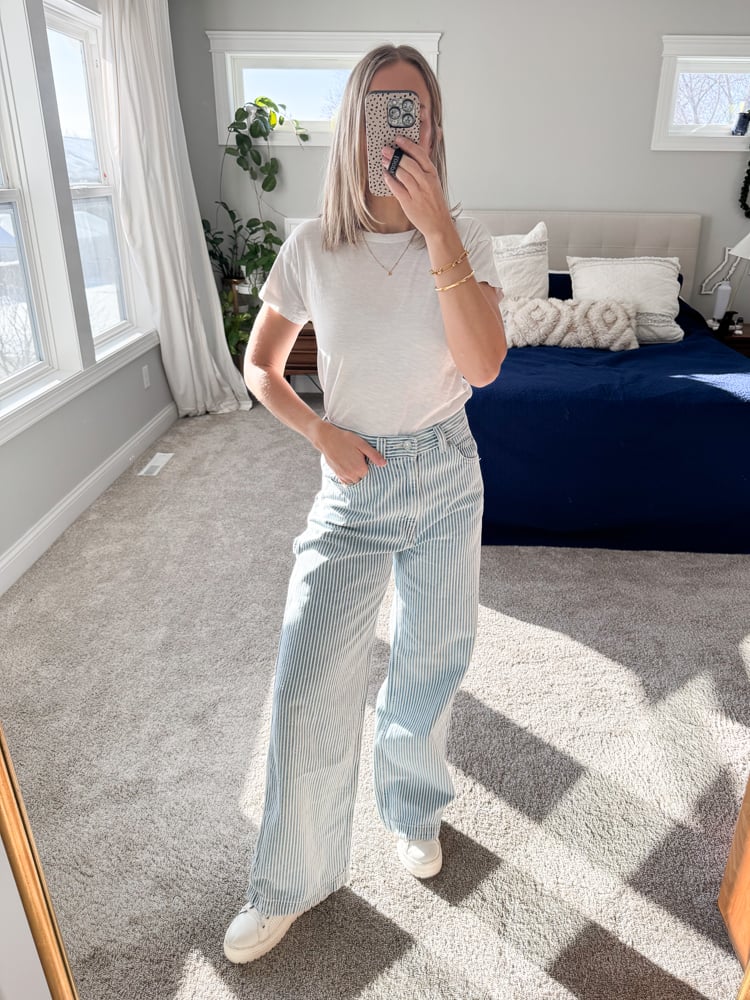 woman wearing white tee with pinstripe jeans