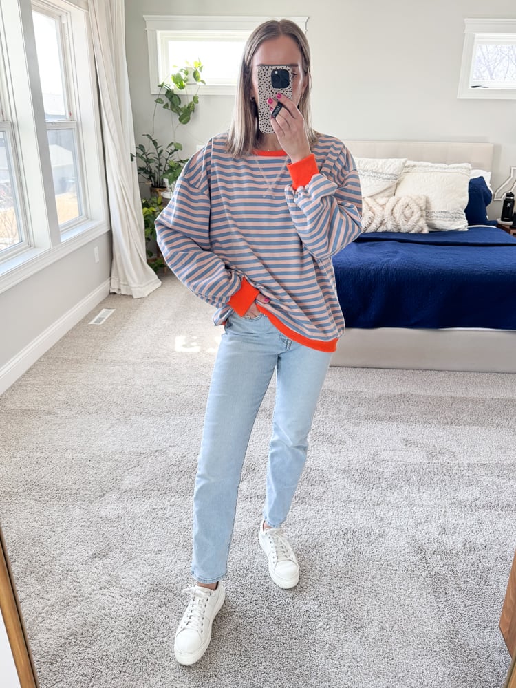 woman wearing striped top with blue jeans