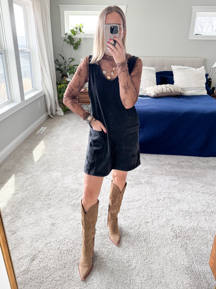 woman wearing black romper and mesh long sleeve top with western boots