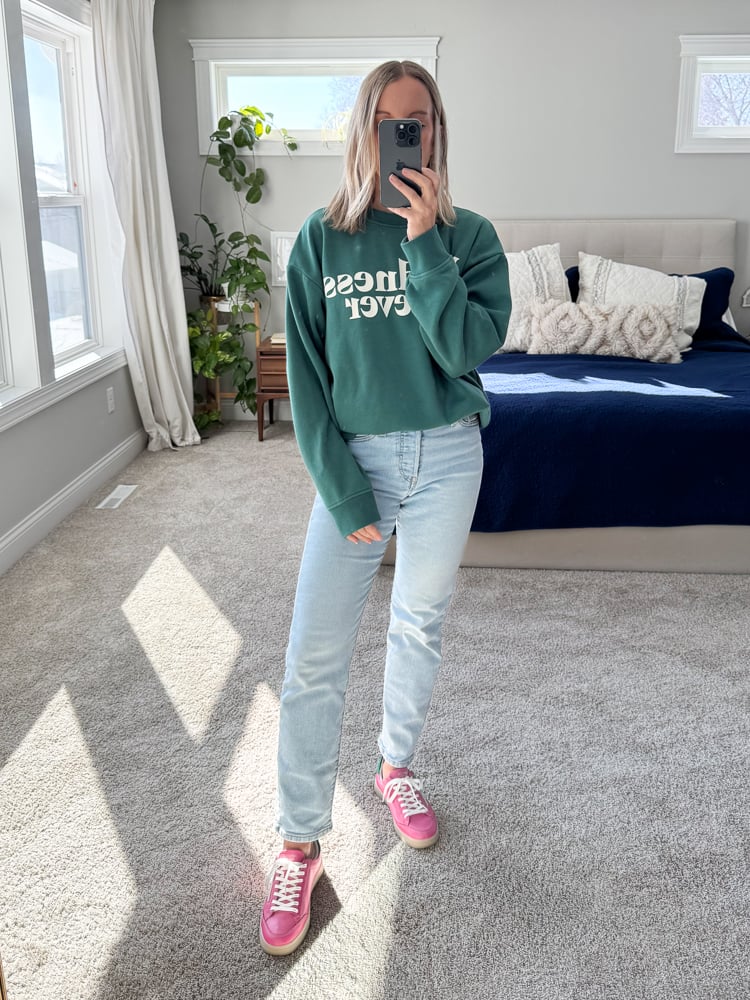 woman wearing sweatshirt and pink sneakers