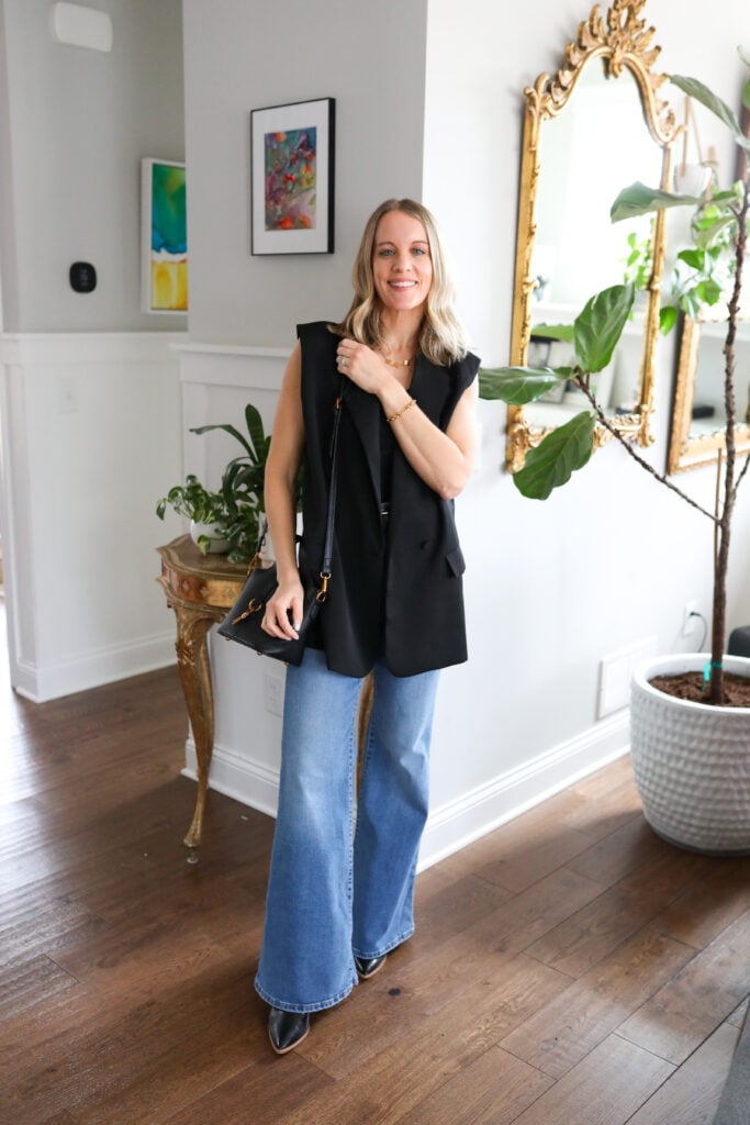 Woman wearing bell bottoms with blazer vest.