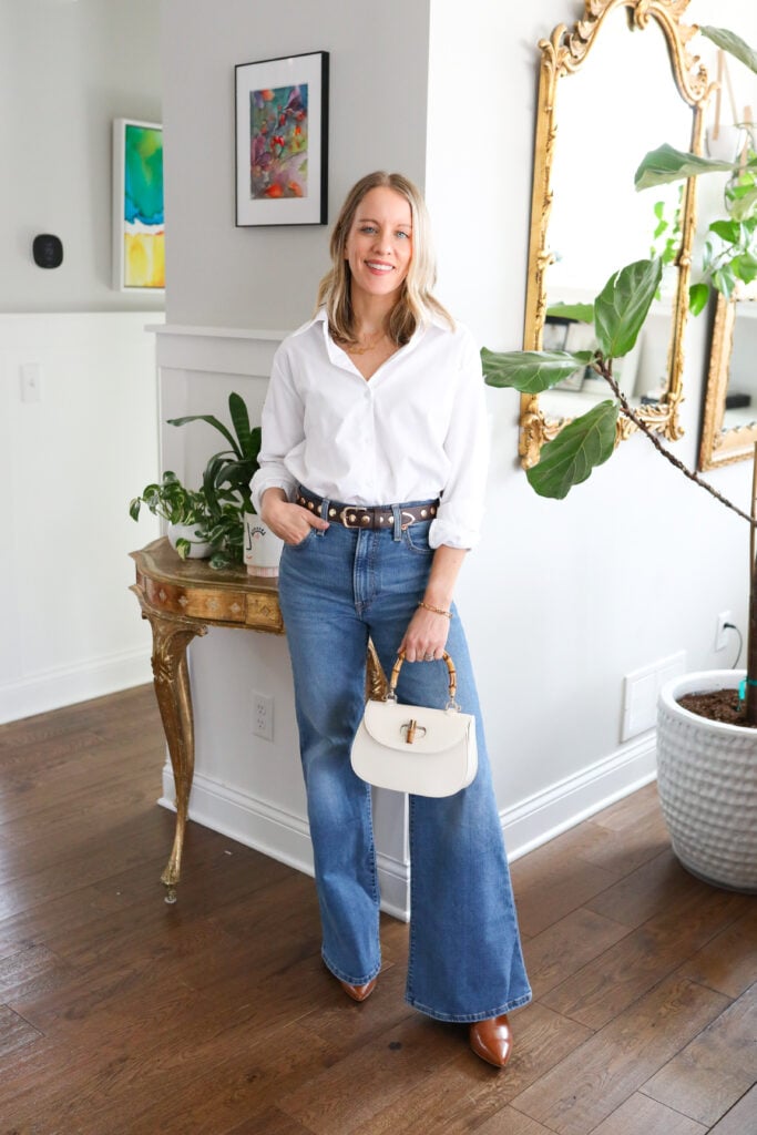 Woman wearing bell bottoms with white button down.