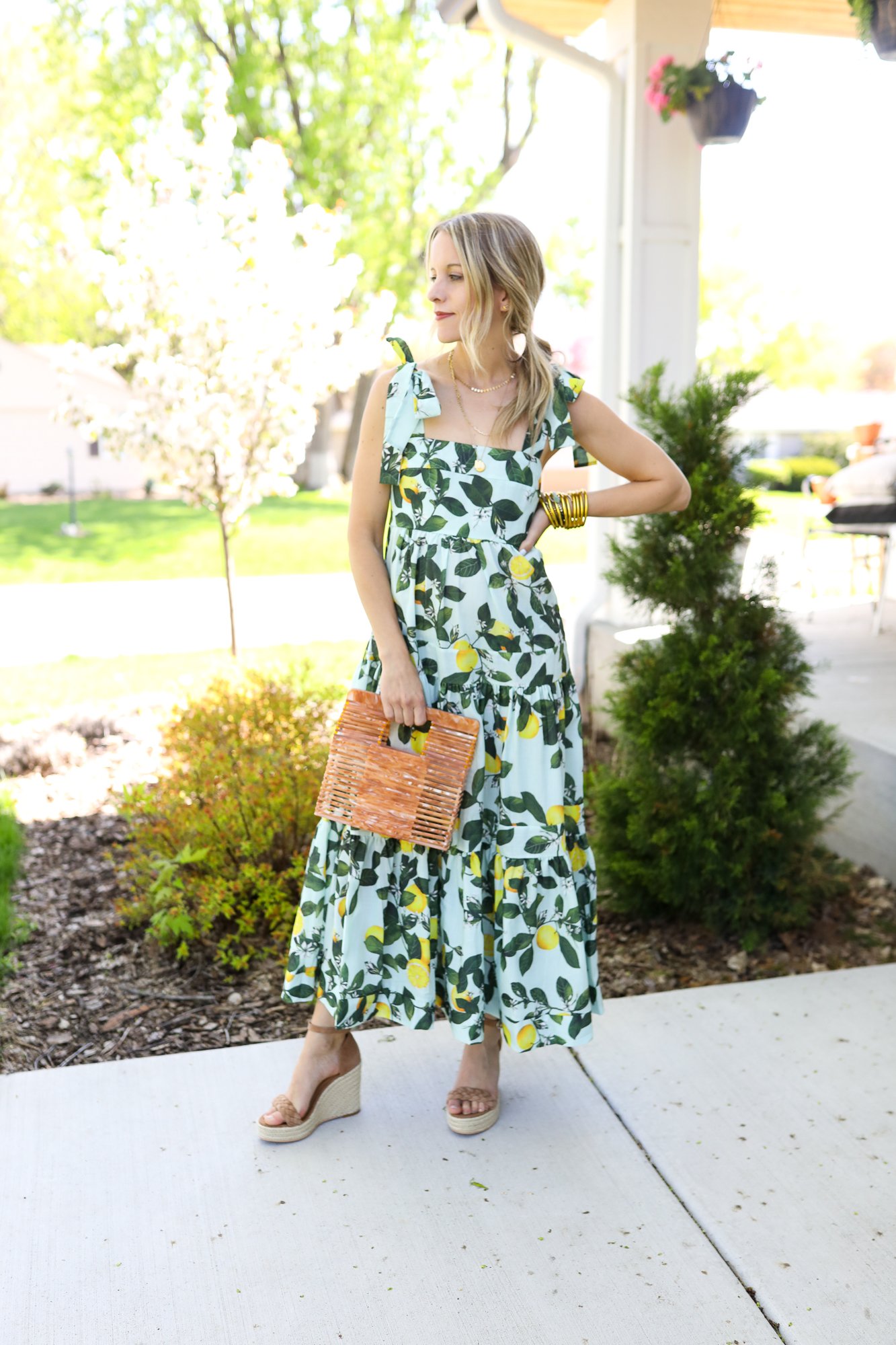 woman wearing lemon printed maxi dress and wedges