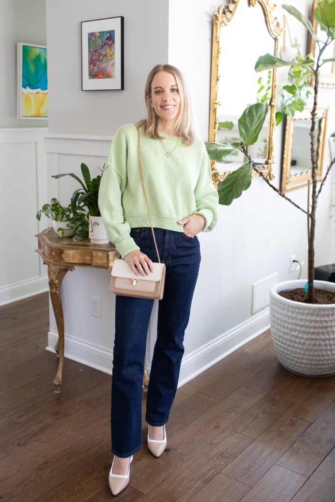 woman wearing green sweater and jeans