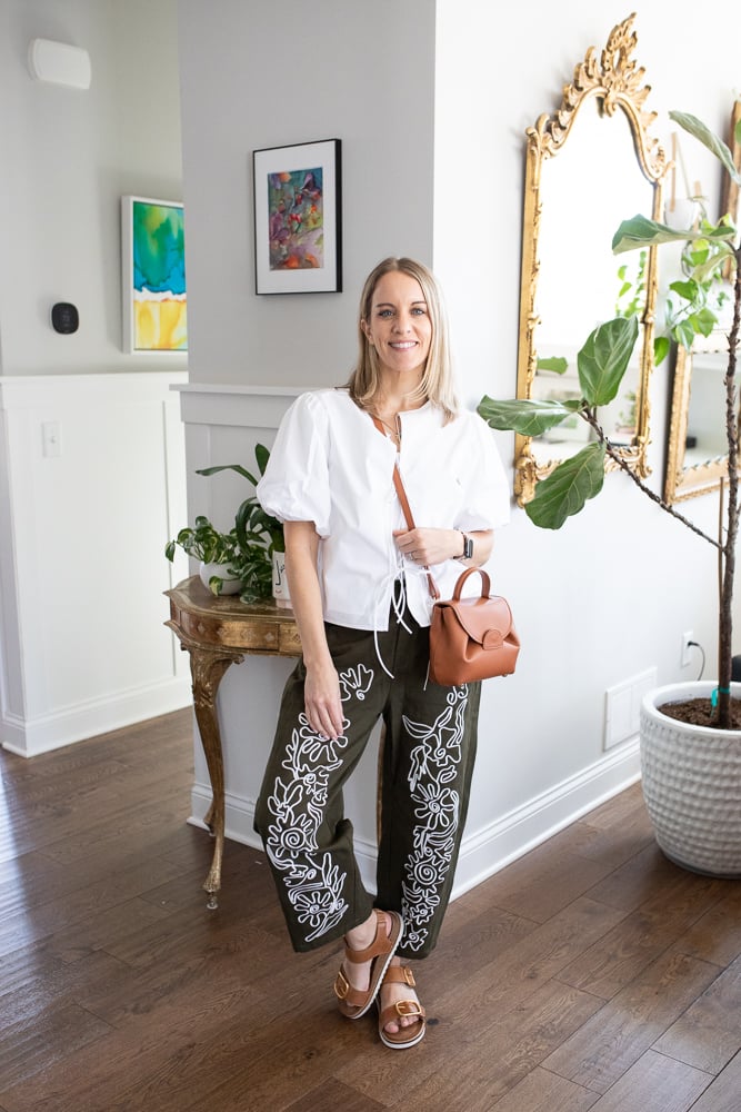 woman wearing trendy barrel jeans and white top