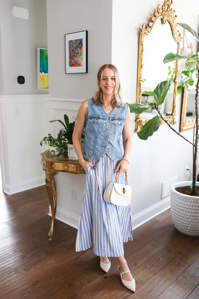 woman wearing denim vest and blue striped dress