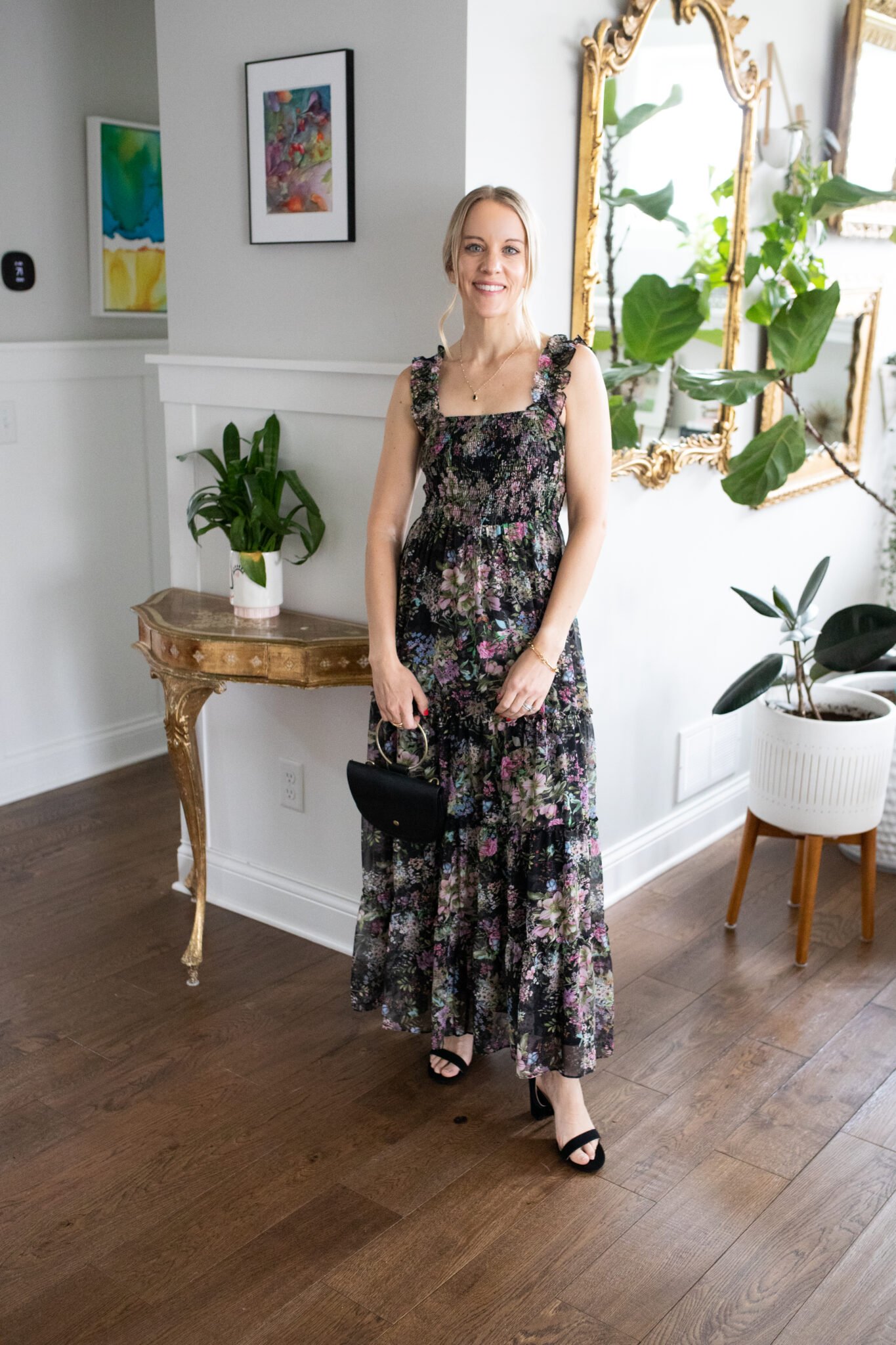 Black floral maxi dress with a smocked bodice and flowy skirt, perfect for an outdoor or evening wedding.
